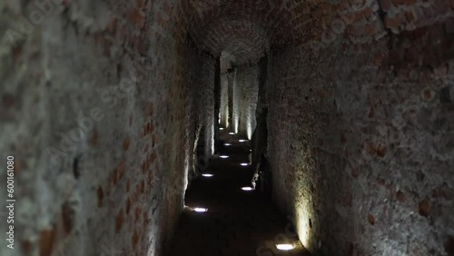 Stone dark corridor of ancient catacombs. Tomb inside old castle. Archeology and medieval ruins