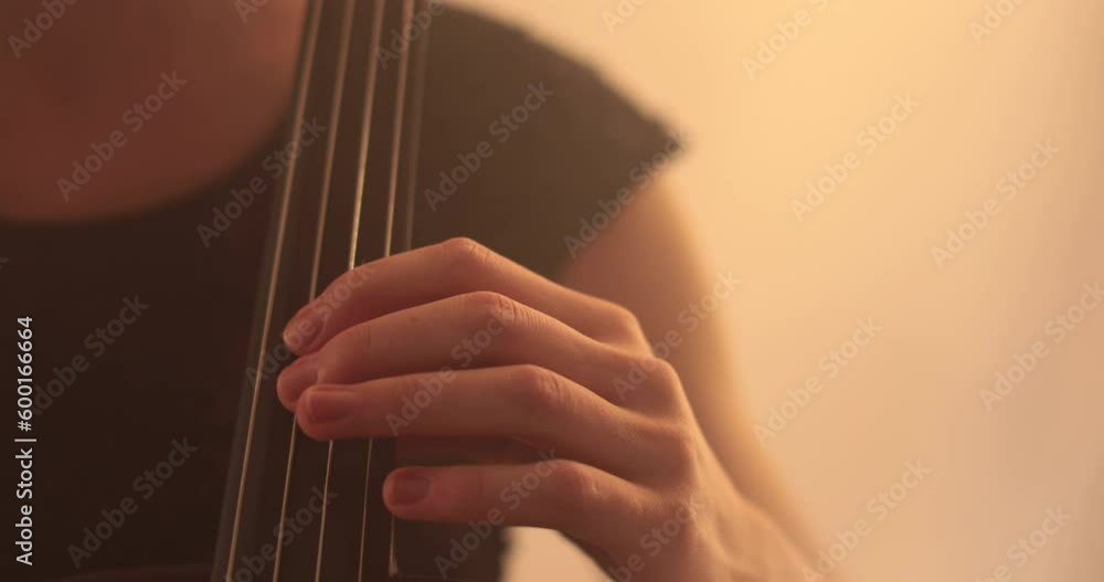 Single woman playing the cello, close-up and medium close-up, cello bow and strings, smooth transitions of the camera from focus to out-of-focus, beautiful filmic, artistic shots. Single woman playing the cello, close-up and medium close-up, cello bow and strings, smooth transitions of the camera from focus to out-of-focus, beautiful filmic, artistic shots.