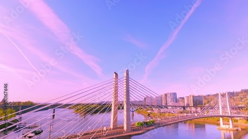 Beautiful Aerial Shot of Tilikum Crossing Bridge with Tram Crossing it During Golden Hour Sunrise in Portland, Oregon