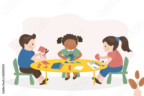 Preschool kids cuts and glues handmade crafts. Smart children use scissors for cutting colorful paper sheets. Education, creativity and art. Creative students with paper and scissors