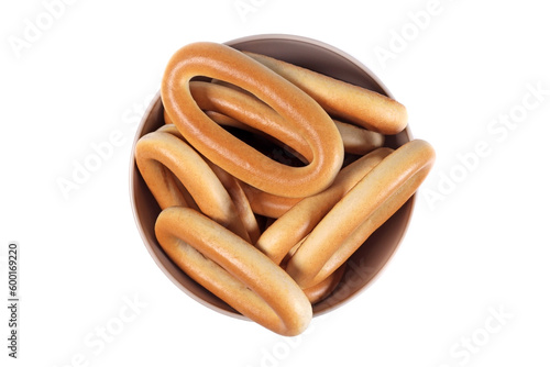 Dry bagels in a bowl isolated on white, top view