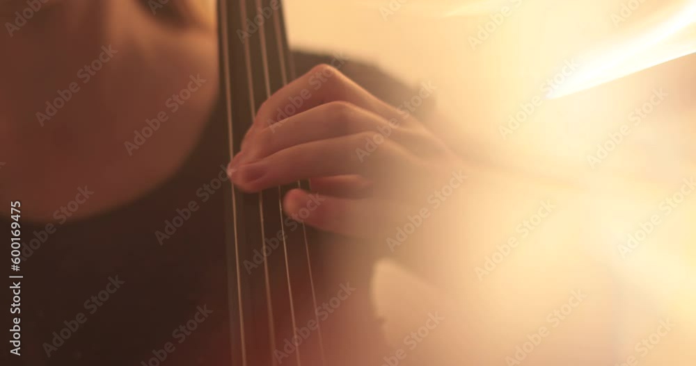 Single woman playing the cello, close-up and medium close-up, cello bow and strings, smooth transitions of the camera from focus to out-of-focus, beautiful filmic, artistic shots. Single woman playing the cello, close-up and medium close-up, cello bow and strings, smooth transitions of the camera from focus to out-of-focus, beautiful filmic, artistic shots.