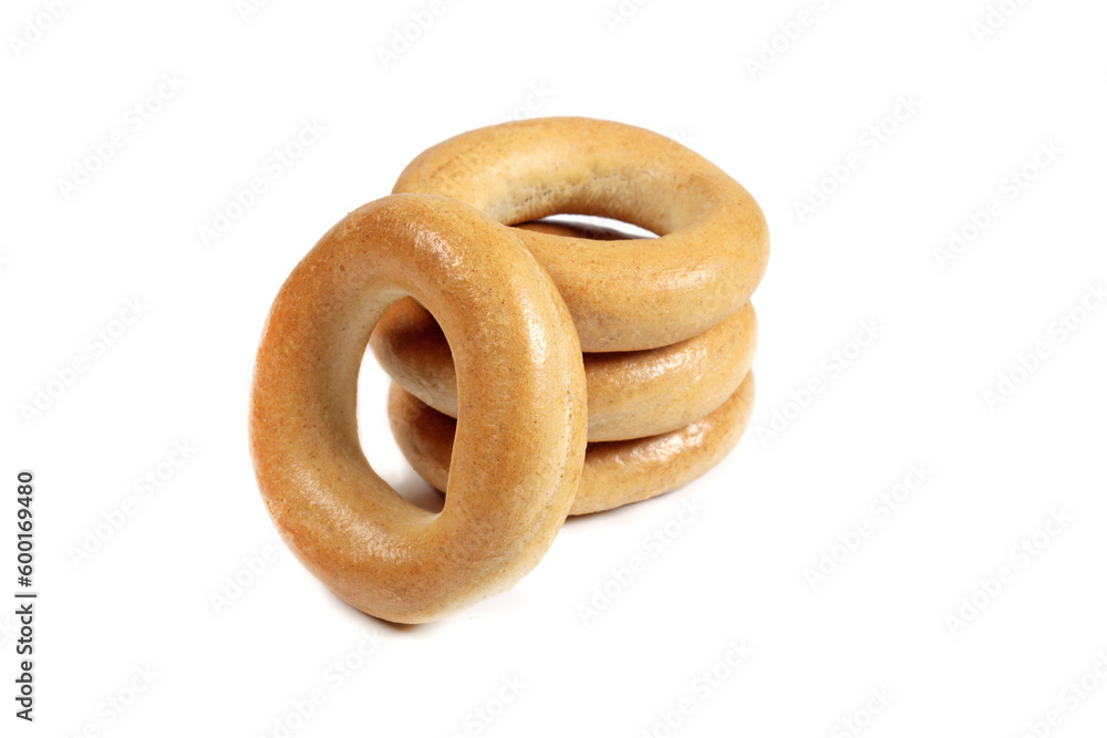 Stack of dry bagels isolated on white