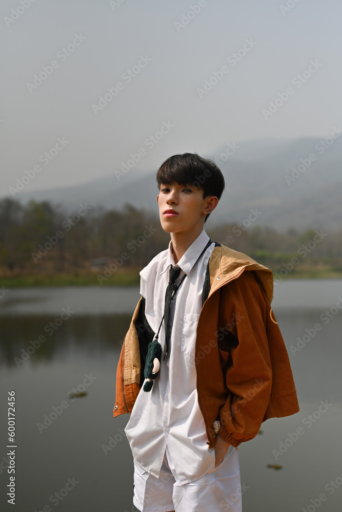 Fototapeta premium Portrait with Asian gay teenage, LGBT boy looking at the camera with attractive expressions, Outdoor, LGBTQ+ concept.