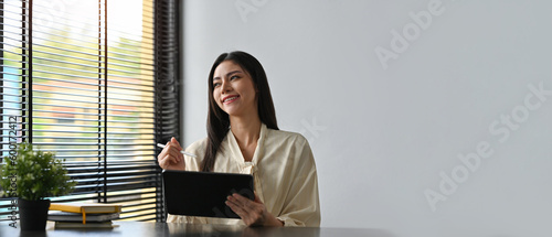 Billede på lærred Copy space and Empty space for advertisement and text with Smiling of Young Businesswoman working with tablet