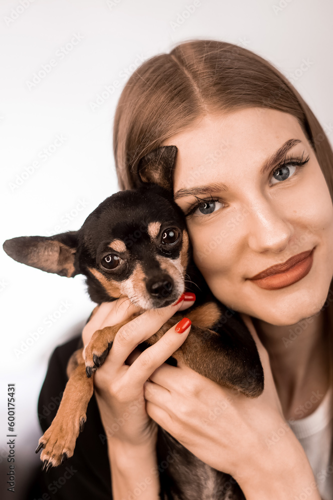 Young blonde girl with dog toyter looking into the frame