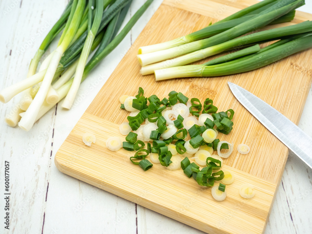 top view of green onion cut on a cutting board top view of green onion cut on a cutting board