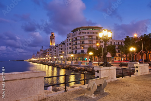 Empty benches and lamp posts at seafront and promenade in Bari, Italy. Romantic, calm, relaxing evening in city. photo