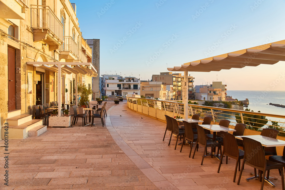 Viewpoint on sunset seascape over Mediterranean sea in European country from wooden terrace. Loneliness concept. One chair and one round table at the terrace. Romantic background.