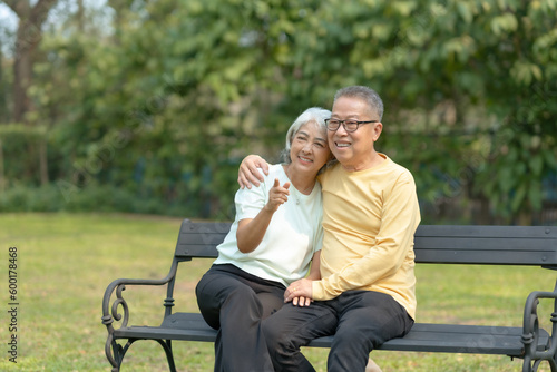 Elderly couple. Asian couple giving love to each other smiling happily. Happy Asian senior couple in the park