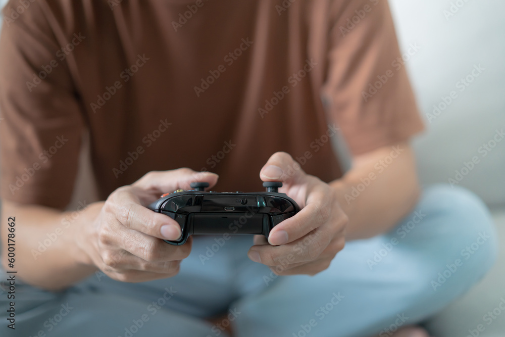Young Asian man gamer controller video console playing holding hobby playful Online Video Game enjoyment eSport Cyber Games Internet. Young Asian man gamer controller video console playing holding hobby playful Online Video Game enjoyment eSport Cyber Games Internet.