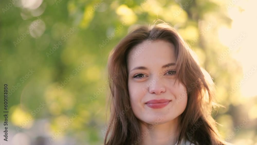 happy young brunette woman on a sunny day in the park enjoys life happy young brunette woman on a sunny day in the park enjoys life