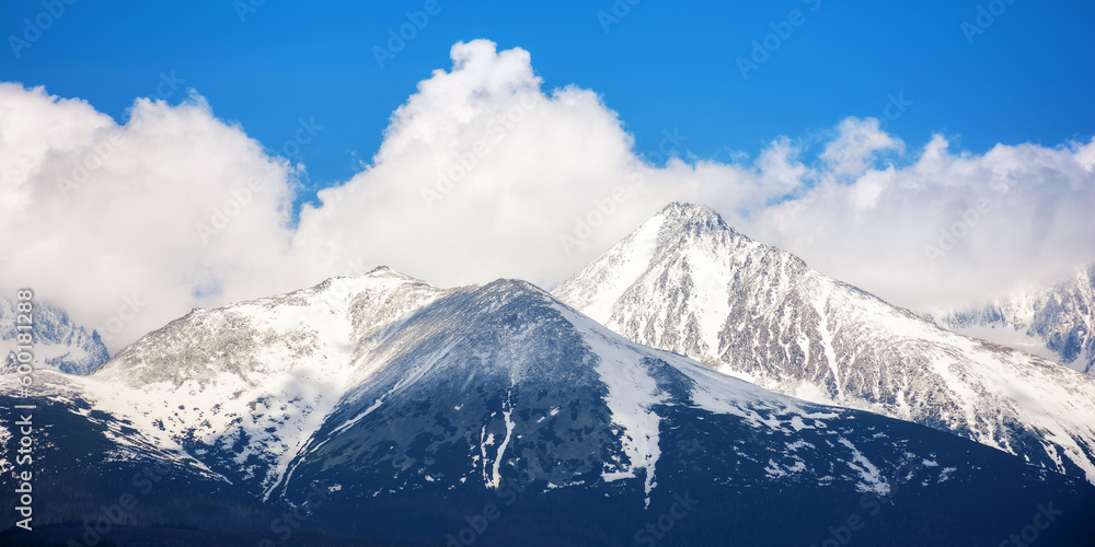 background image of high tatra peaks in spring. sunny scenery with clouds