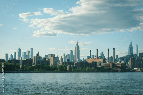 View of the Manhattan skyline and Empire State Building across the East River from Domino Park  Brooklyn  New York