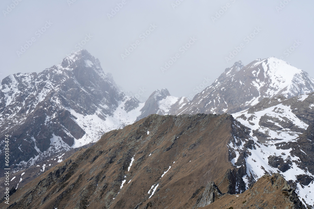 Landscape with snow covered mountains rocky peak and ridges in the background. Uia di Mondrone and Ometto, Lanzo Valleys, Piedmont, Alps