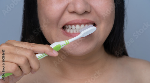 Asian woman brushing her teeth dental care concept Daily routine after bathing brush your teeth with a toothbrush Clean your mouth in the morning and evening. oral hygiene and care