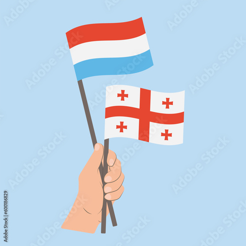 Flags of Luxembourg and Georgia, Hand Holding flags