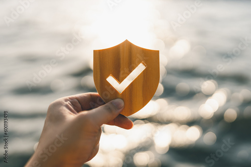 Businessman holding shield protect icon, Security protection and health insurance. The concept of family home, foster care, homeless support, protection, health care day and home school education.