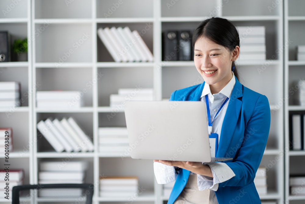 Young professional businesswoman working in the office room with laptop computer. Young professional businesswoman working in the office room with laptop computer.