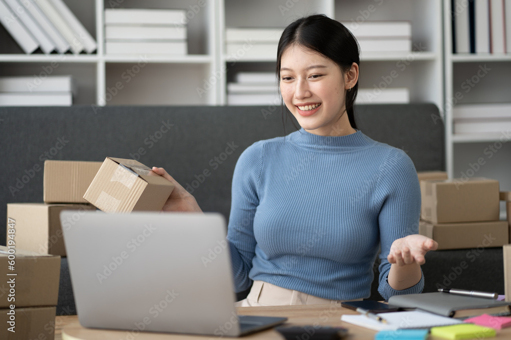 Young SME business owner promoting her store online, getting customer engagement. Young SME business owner promoting her store online, getting customer engagement.