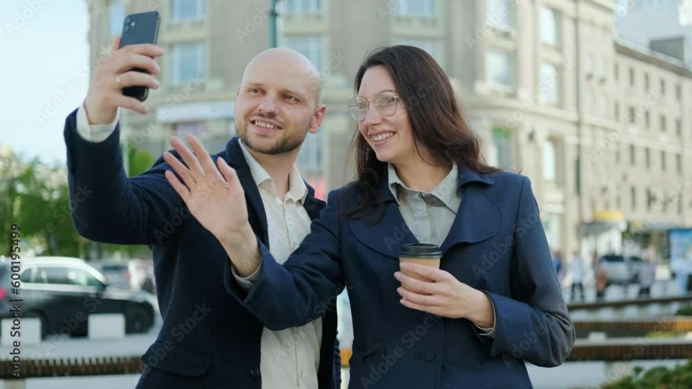 A woman in a business suit presses the phone button. A man and a woman begin to communicate via video online using a smartphone A woman in a business suit presses the phone button. A man and a woman begin to communicate via video online using a smartphone
