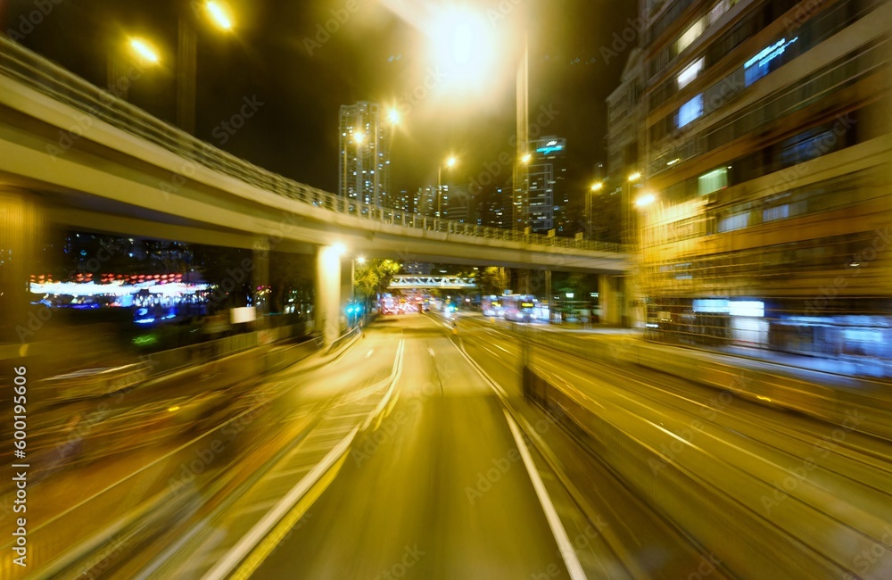 Night cityscape of Causeway Bay Downtown in Hong Kong with busy traffic of cars under a highway bridge near Victoria Park (motion blur effect)
a captivating glimpse into the vibrant urban experience