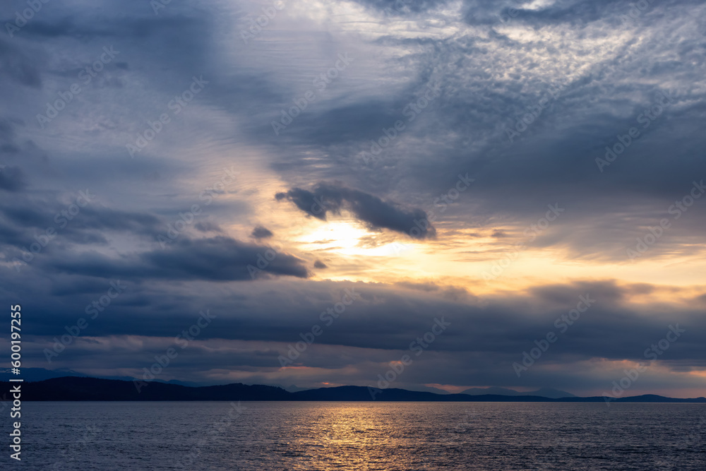 Cloudy Cloudscape during stormy everning on the West Coast of Pacific Ocean. British Columbia, Canada. Sunset Sky