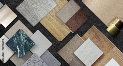 home interior material samples selection contains brushed stainless, metallic laminated, wooden vinyl flooring tiles, laminated tiles, marble stone, stone tiles placed black stone table background. photo