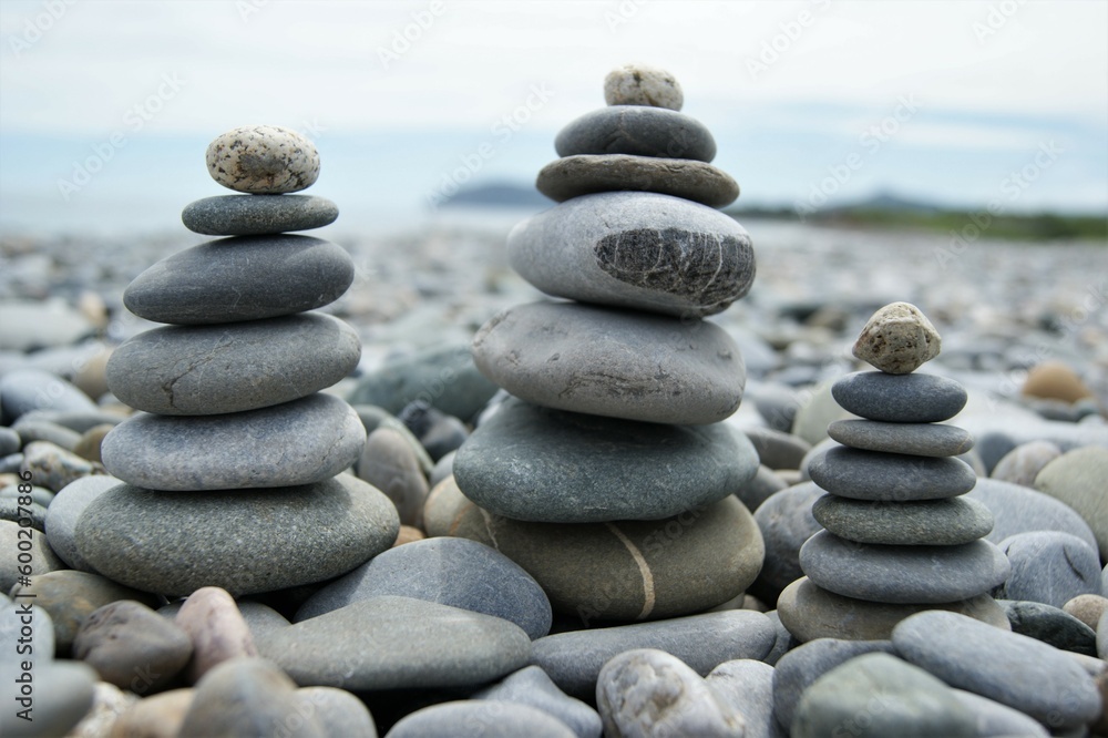 Towers made of pebbles. Three Zen towers on a rocky beach. Towers made of pebbles. Three Zen towers on a rocky beach.