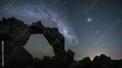 Milky Way galaxy rising in the night sky with rock arch in the foreground, Cederberg Mountains, South Africa
