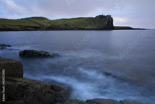 Incoming tide at Sunset with Duntulm Castle in the background, Isle of Skye, Scotland, UK.