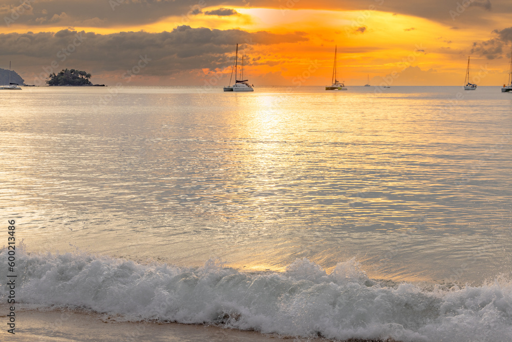 Magical sun setting on the beach of Naiyang on the island of Phuket in Thailand. Magical sun setting on the beach of Naiyang on the island of Phuket in Thailand.