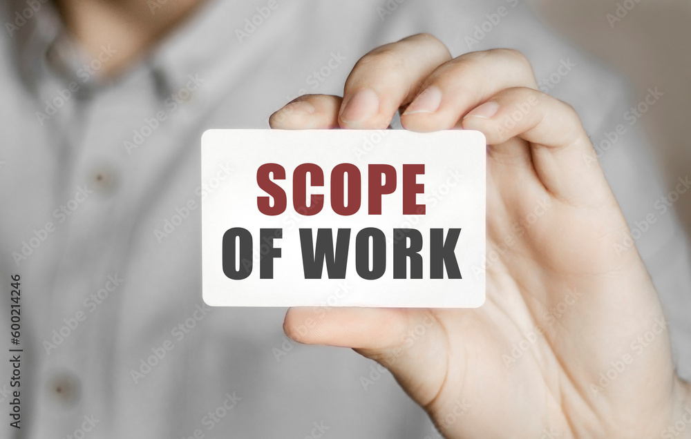 Card with text SCOPE OF WORK in a man's hand Card with text SCOPE OF WORK in a man's hand