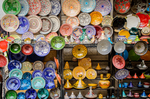 Colourful ceramic plates and pots displayed at Morocco Marrakech medina souks.