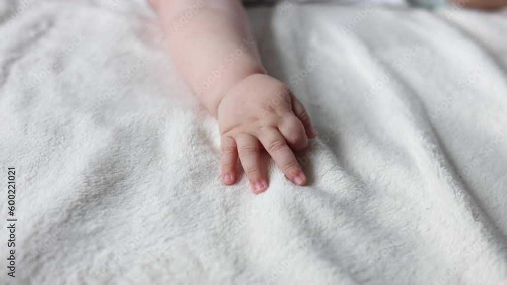 close up baby body parti cute hand fingers legs sole sitting on bed blanket. mother kissing infant toddler feet massage with hands. child moving uncontrollably.motherhood concept advertising 4k close up baby body parti cute hand fingers legs sole sitting on bed blanket. mother kissing infant toddler feet massage with hands. child moving uncontrollably.motherhood concept advertising 4k