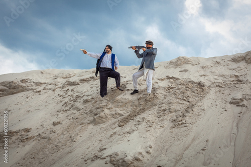 The Taliban are planning terrorist attacks with weapons. Arab male soldier in a headdress made of the national keffiyeh with weapons in his hands.