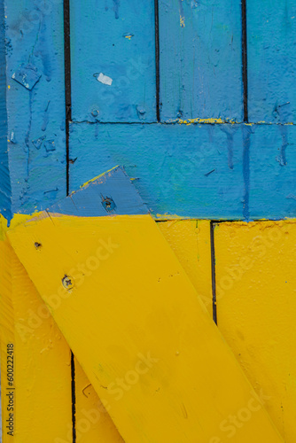 Blue and yellow colored wood surface close up. Colors of Ukrainian flag