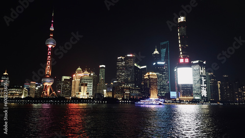 Shanghai, China: March 17 2017; Light show on the Bund in Shanghai, eastern China. City at night illuminated. Illuminated boat on the Huangpu River.