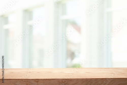 Empty wooden table top on window blur and abstract with sunlight. For mounting product display or visual