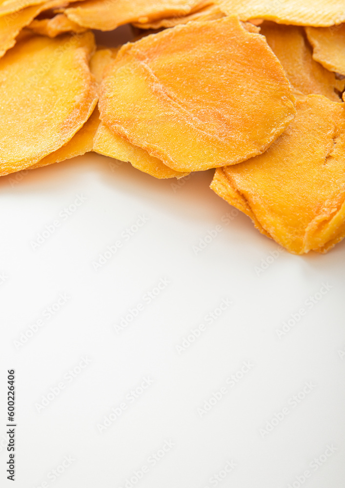 Dried large sweet mango slices on white background.Macro Dried large sweet mango slices on white background.Macro