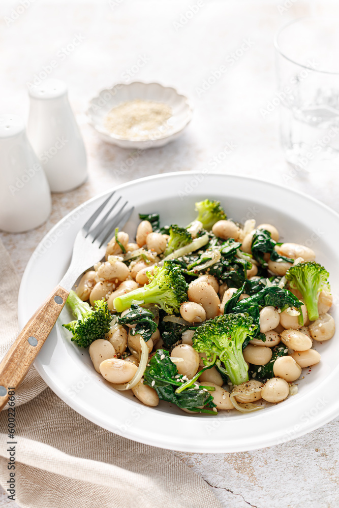White beans stewed with spinach and onion, healthy vegan food White beans stewed with spinach and onion, healthy vegan food