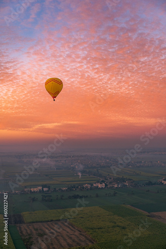 Hot air balloons flying over the Valley of the Kings during an amazing sunrise in Luxor, Egypt. © Lluislc