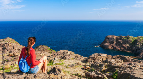 Tourist woman with backpack on Cap de Creus, Costa Brava, Spain