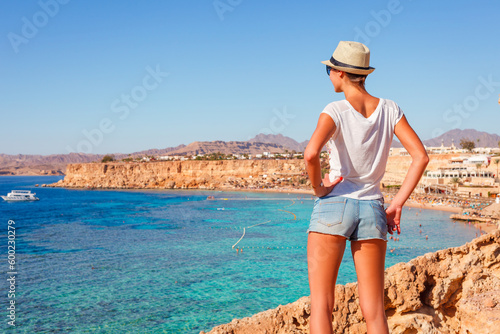 Tourist woman on the Red Sea beach in Sharm el Sheikh, Sinai, Egypt