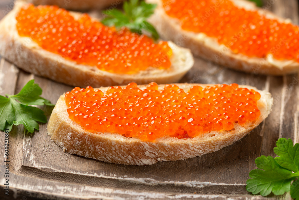 Salmon red caviar sandwiches on wooden board Salmon red caviar sandwiches on wooden board
