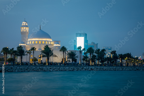 White Jawza Al Qahtani Mosque with downtown in the background, Al Khobar, Saudi Arabia photo