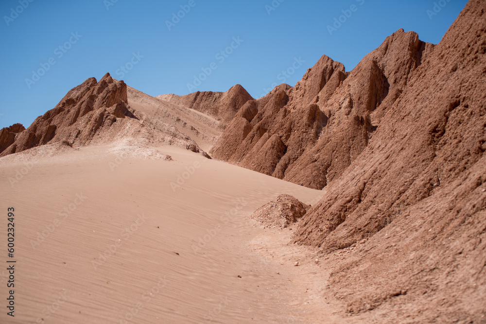 Fototapeta premium desert rocky valley covered by sand in the Atacama