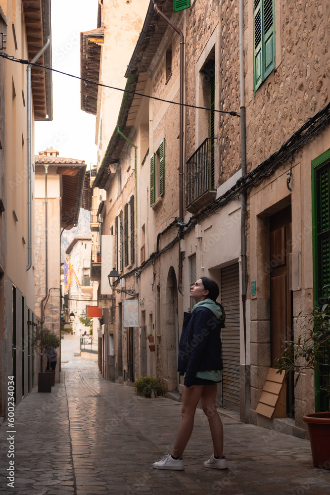 real woman visiting walking an old village of Majorca, Spain
