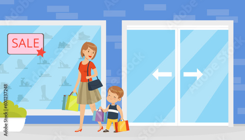 Polite little boy helping his mother to carry shopping bags with purchases. Well mannered kid, good manners and respect cartoon vector photo