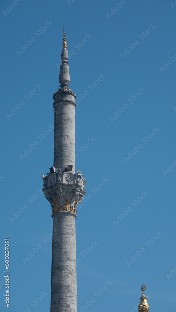 Classic ottoman style mosque minaret view with a clear blue sky. Minaret of a mosque from muslim islamic culture, minarets on blue sky , historic traditional minaret Classic ottoman style mosque minaret view with a clear blue sky. Minaret of a mosque from muslim islamic culture, minarets on blue sky , historic traditional minaret